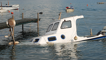 a small boat sinking, representing boating accidents